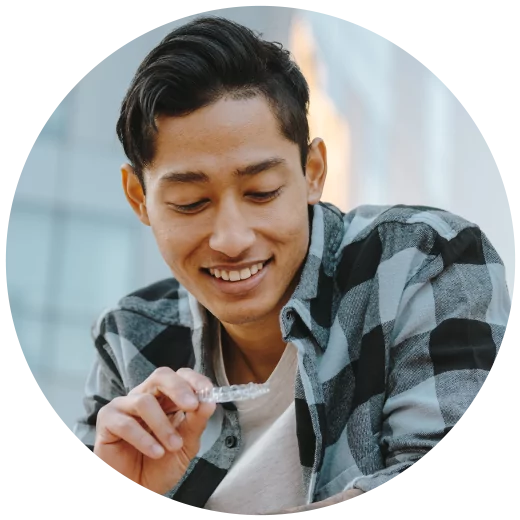 Man looking at his Reveal clear aligner